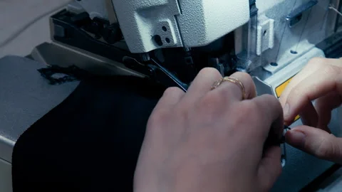 Woman's Hands Sewing Fabric On The Automatic Sewing Machine. Close-Up Seamstress Stock Footage 254373316