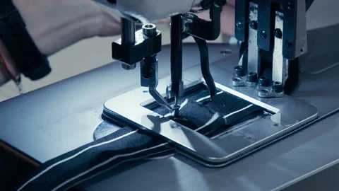 Woman's Hands Sewing Fabric On The Automatic Sewing Machine. Close-Up Seamstress Stock Footage 254373331