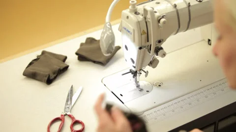 Woman's hands sewing with a sewing machine in a dressmaker's factory Stock Footage 31441497