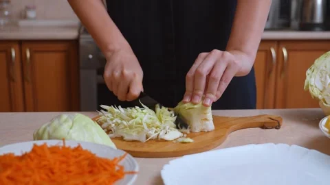 Woman's hands shredding fresh cabbage for salad Stock Footage 328594319