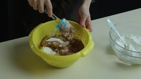 Woman's hands shuffle chocolate dough Stock Footage 265892086