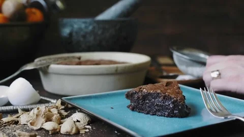 Woman's hands sifting powdered sugar over almond cake	 Stock Footage 75759550