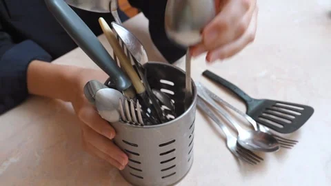 Woman's hands sorting clean kitchen utensils Stock Footage 323949572