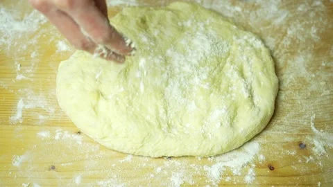 Woman's hands sprinkle dough and roll it out. Top view Stock Footage 220683069