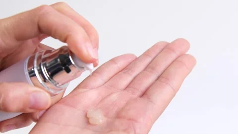 A womans hands squeeze out a cream or serum for face, body, or hand care from a Stock Footage 318544801