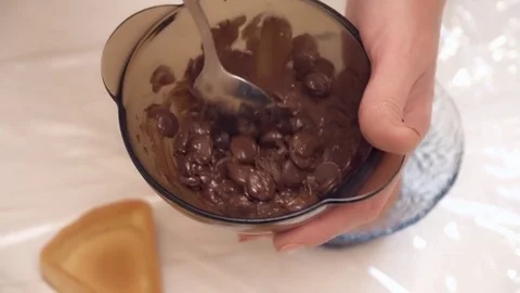Woman's hands stirring the chokolate in the bowl Stock Footage 74467757