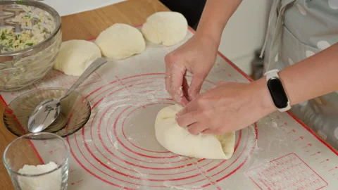 A woman's hands stuffing dough with a savory filling and sealing the pie Stock Footage 315906415
