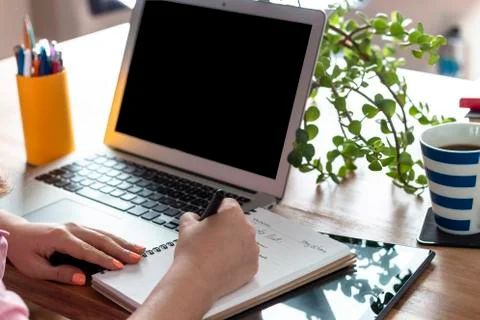 Woman's hands Tablet at home, with a computer during the coronavirus quaranti Stock Photos