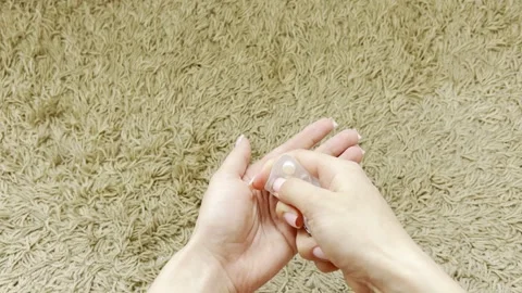 Woman's hands taking a white pill out of a blister pack for medical treatme.. Stock Footage 335141484