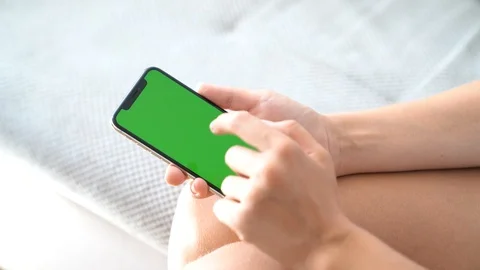 Woman's hands tapping smartphone green screen Stock Footage 113287810