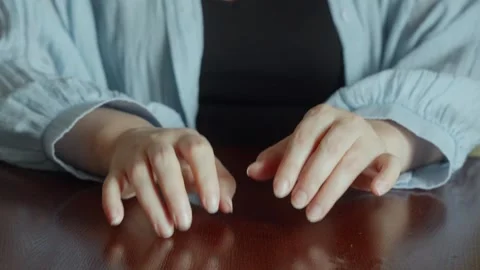 Womans hands tapping on wooden table, close-up, anticipation concept Video stock 320737552
