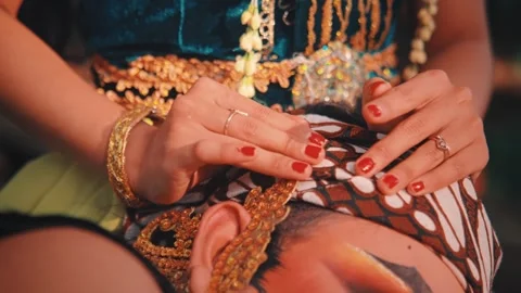 Woman's Hands Tenderly Caressing Man's Head in Batik Headwrap Stock Footage 313469240