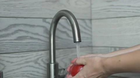 Woman's Hands Thoroughly Wash Vegetable Tomato under Water from the Kitchen Fauc Stock Footage 158238334