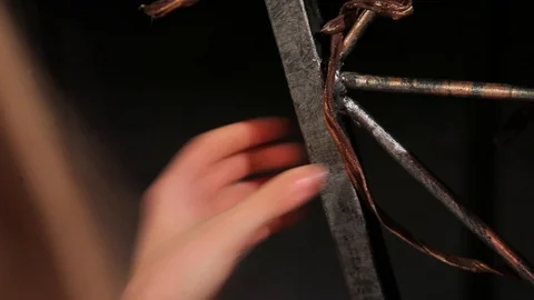 Woman’s hands touching iron gate with pattern. Close-up, concept, curious Stock Footage 100129557
