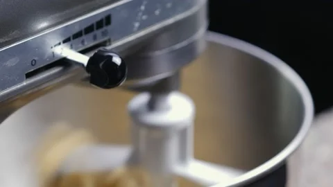 Woman's hands turn off the planetary mixer that works the dough - blurred Stock-Footage 167689095