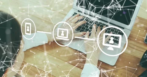 Woman's hands typing on keys activating digital network linking phone laptop 動画素材 317123886