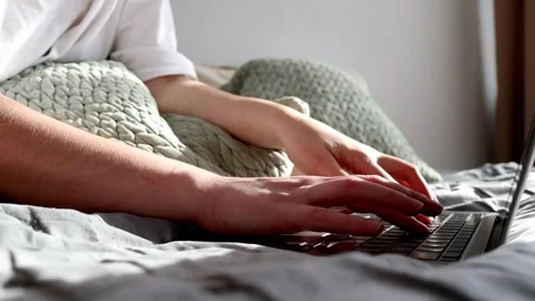 Woman's hands typing on laptop in bed. Stock Footage 303282523