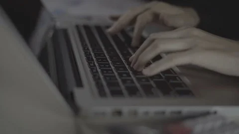 Woman's hands typing on laptop computer keyboard in the office Stock Footage 78704336
