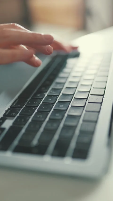 Womans hands typing on a laptop computer keyboard at home Stock Footage 335621496
