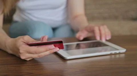 Woman's hands typing security code from credit card Stock Footage