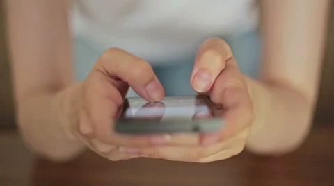 Woman's hands typing text messages on smart phone Stock Footage