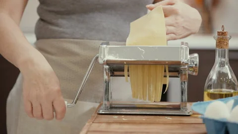 Woman's hands use a pasta cutting machine. Stock Footage 86018072