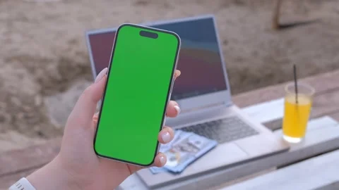 Woman's hands use smartphone with laptop, money dollars on the beach closeup Stock Footage 272631425