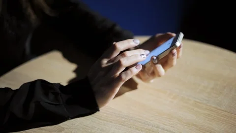 Womans hands uses the phone, scrolls through photos in app. Close-up Stock Footage 98127534
