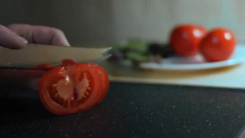 Woman's hands using kitchen knife slicing fresh tomato on cutting board. Healthy Stock Footage 144241626