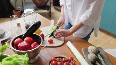 Woman's hands using kitchen knife cutting fresh cucumber on wooden cutting board 스톡 동영상 164761877