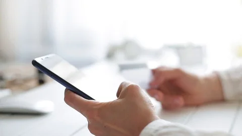 Woman's hands using of a mobile phone and credit card shopping pay online. Stock Footage 110791980