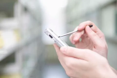Woman's Hands Using PDA In Library Foto stock