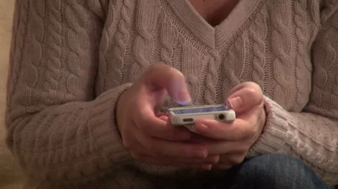 Woman's hands using a smart phone, text messaging, typing Stock Footage 33796980