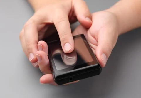 Woman's hands using a smart phone Stock Photos