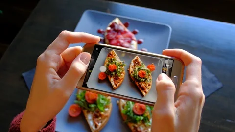 Woman's hands Using Smartphone Take Photo Of Food Before Eating In Restaurant Video stock 104416487