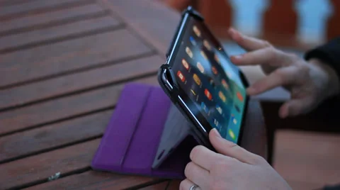 Womans hands using a tablet outdoors. Stock Footage 36533964