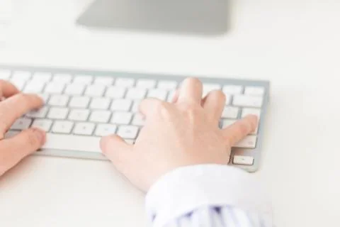 Woman's hands using a wireless keyboard Stock Photos
