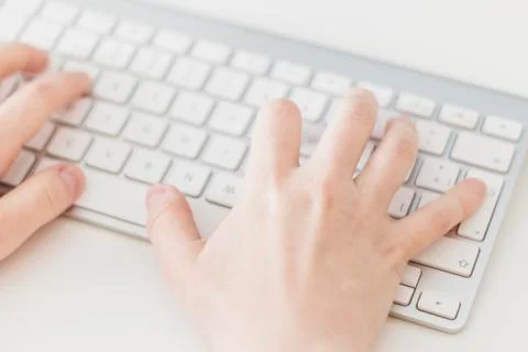 Woman's hands using a wireless keyboard Stock Photos