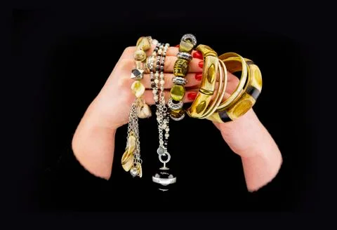 Woman's hands with various bracelets Stock Photos
