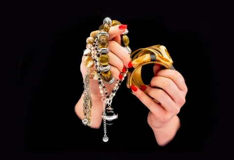 Woman's hands with various bracelets Stock Photos