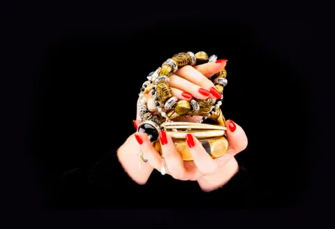 Woman's hands with various bracelets Stock Photos