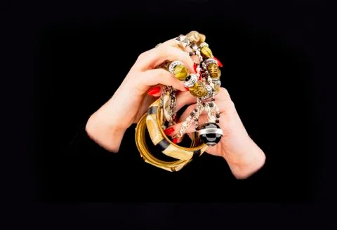Woman's hands with various bracelets Stock Photos