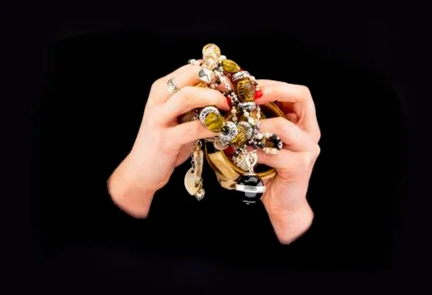Woman's hands with various bracelets Stock Photos