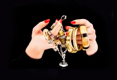 Woman's hands with various bracelets Stock Photos