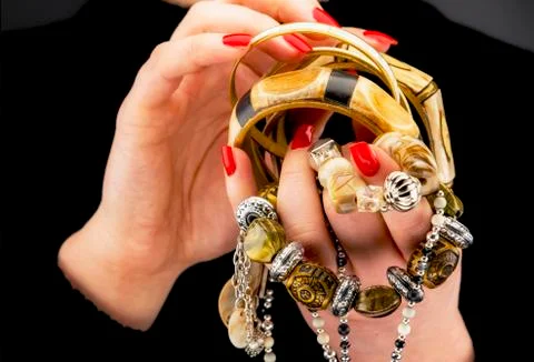 Woman's hands with various bracelets Stock Photos