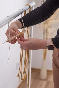 Woman's hands weave macrame decor. Handicrafts advertisement. Copy space Stock Photos