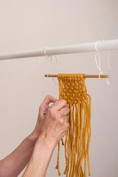 Woman's hands weave macrame decor. Handicrafts advertisement. Copy space Stock Photos
