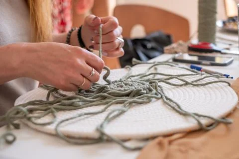 Woman's hands weave macrame decor. Handicrafts advertisement. Copy space Stock Photos