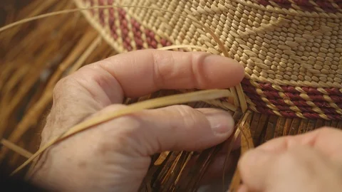 Womans hands weaving a straw hat Stock Footage 104869380