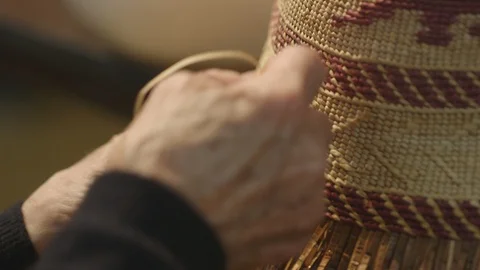 Womans hands weaving a straw hat Stock Footage 104869420